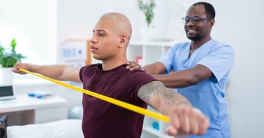 A physical therapist works with a patient 