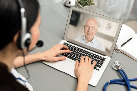 Doctor talking with senior patient via virtual visit