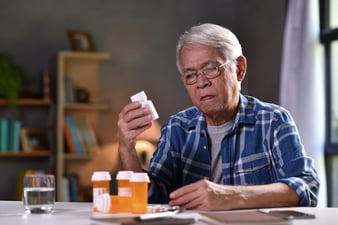 Patient with his pill bottles
