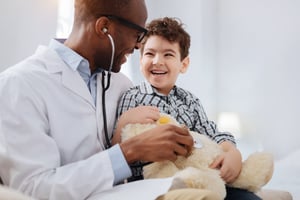 doctor with child and teddy bear