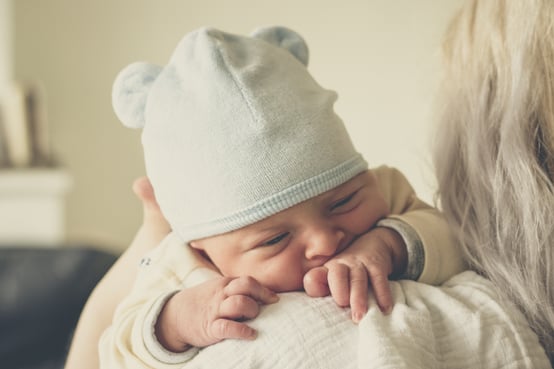 mother holding baby