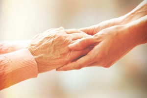 Two people hold hands
