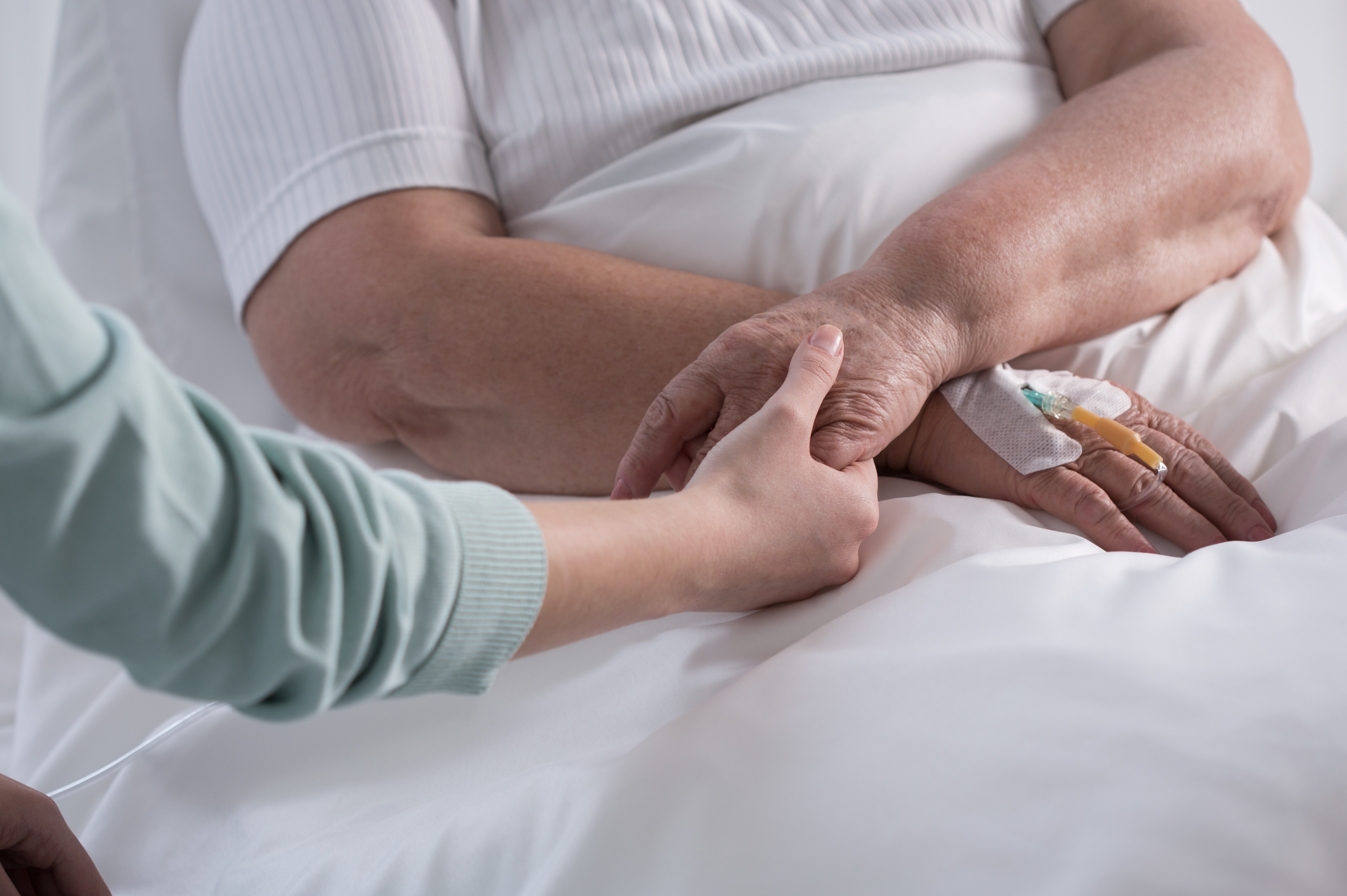 Nurse comforts palliative care patient