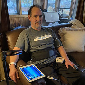 Greg, the patient using HRS solutions to manage COVID-19 at home